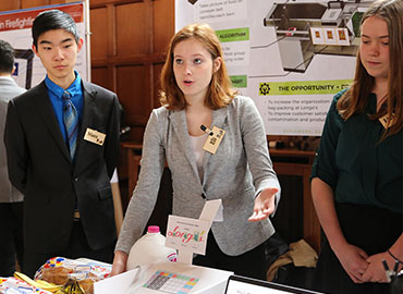Engineering Eli Scott (centre) presents her team’s design for expediting the use of reusable bags at Longo’s grocery stores