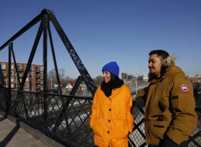 Zahra Ebrahim and Kofi Hope on a bridge in winter coats