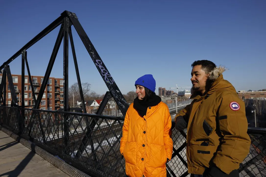 Zahra Ebrahim and Kofi Hope on a bridge in winter coats
