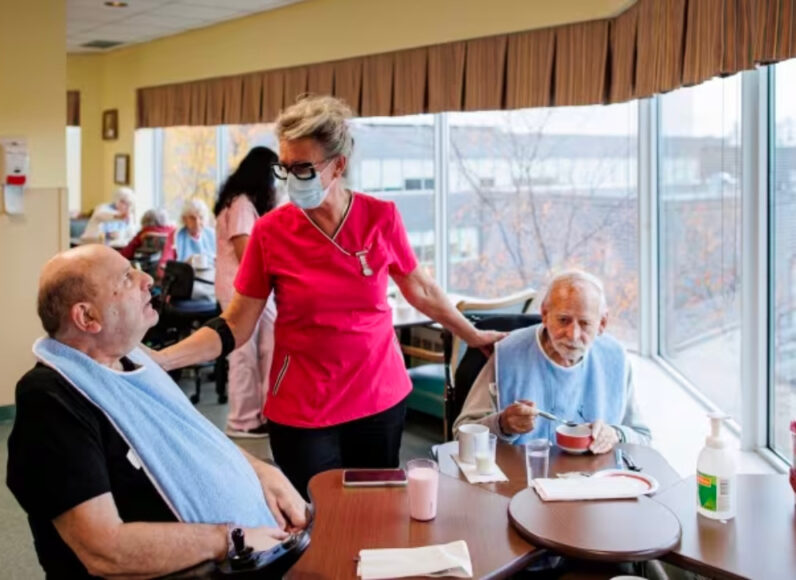 A caretaker and two residents of a long-term care facility