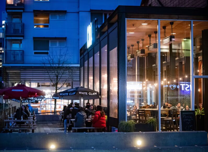 People dine on a patio at a restaurant in Vancouver, B.C
