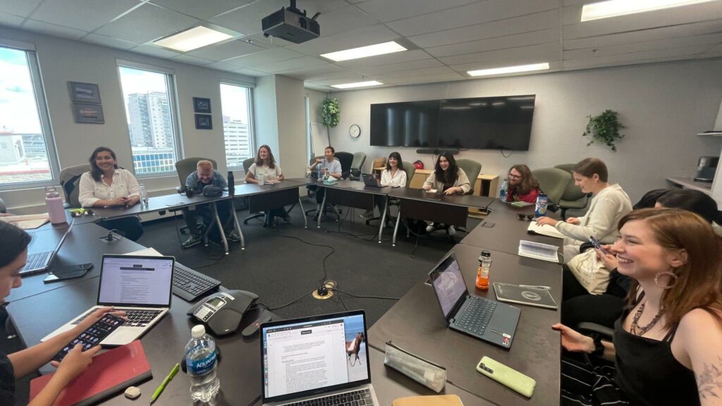 Students interview Emily King in large meeting room