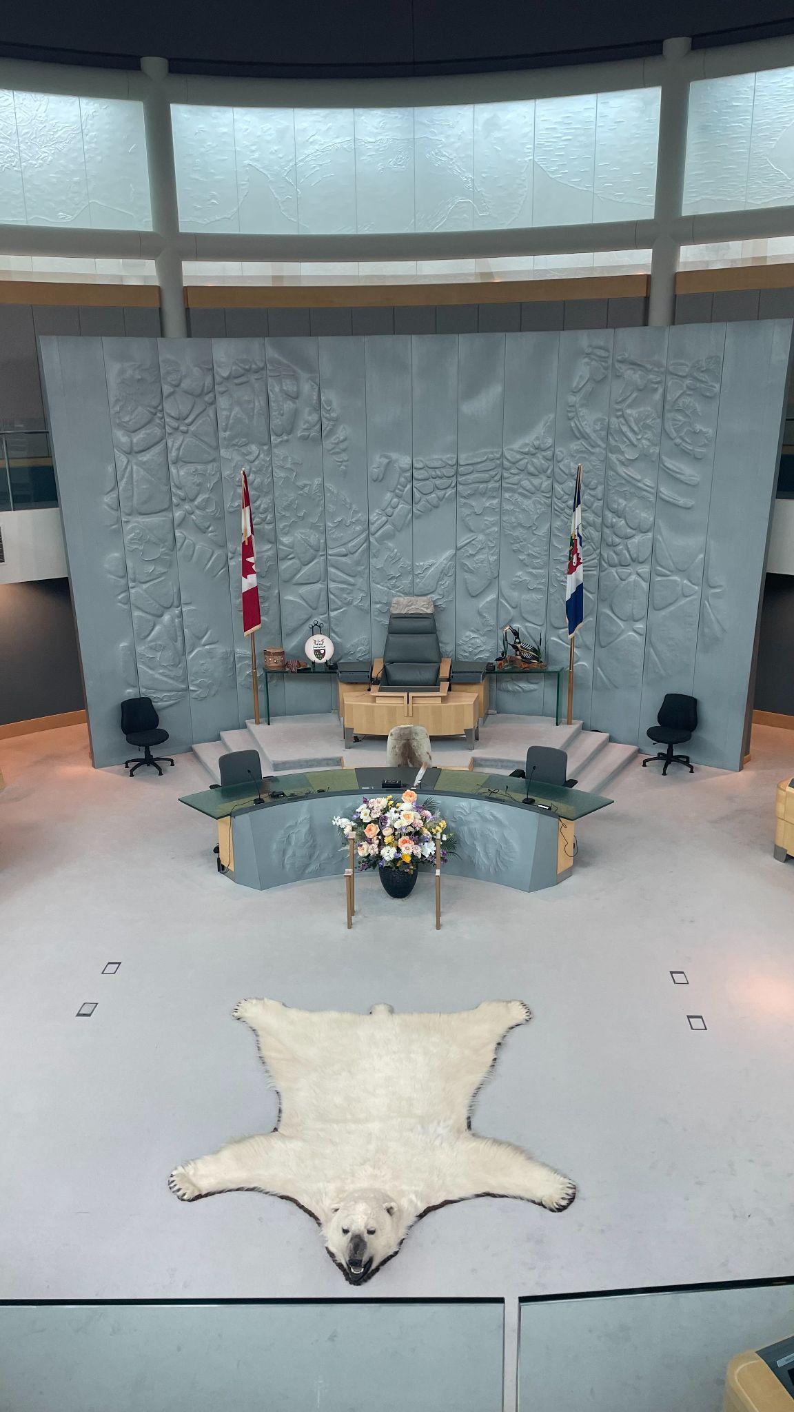 Interior of Council Chamber showing desk, furled flags, and a polar bear rug