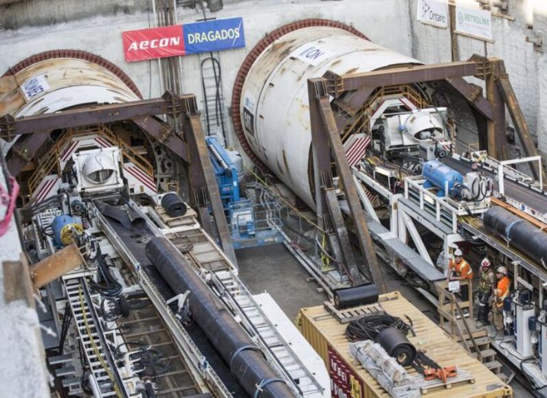 Workers are dwarfed standing beside two large boring machines on Eglinton Ave. E. in 2015. Years late and massively over budget, the Eglinton Crosstown LRT highlights local difficulties with tunneling.