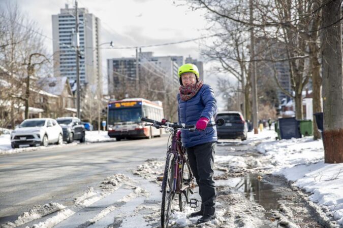 Winter cyclist Judith Butler with her bike on High Park Avenue near her home.