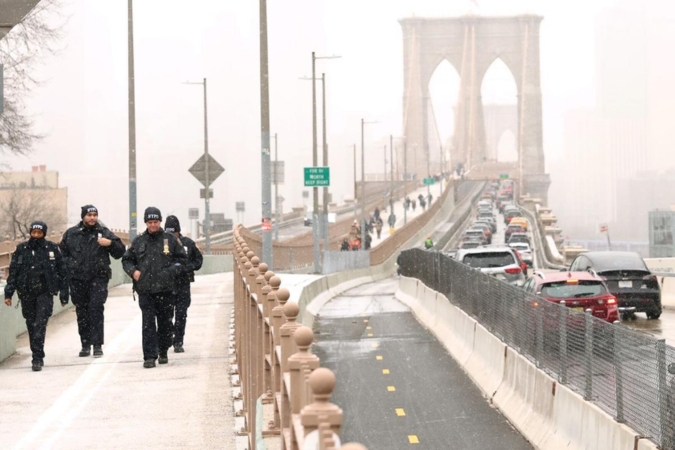 Cars drive along the Brooklyn Bridge preparing to cross into Manhattan on Jan. 06 in New York City.